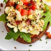 pinterest image of Breakfast Egg Salad with Bacon on a piece of toast