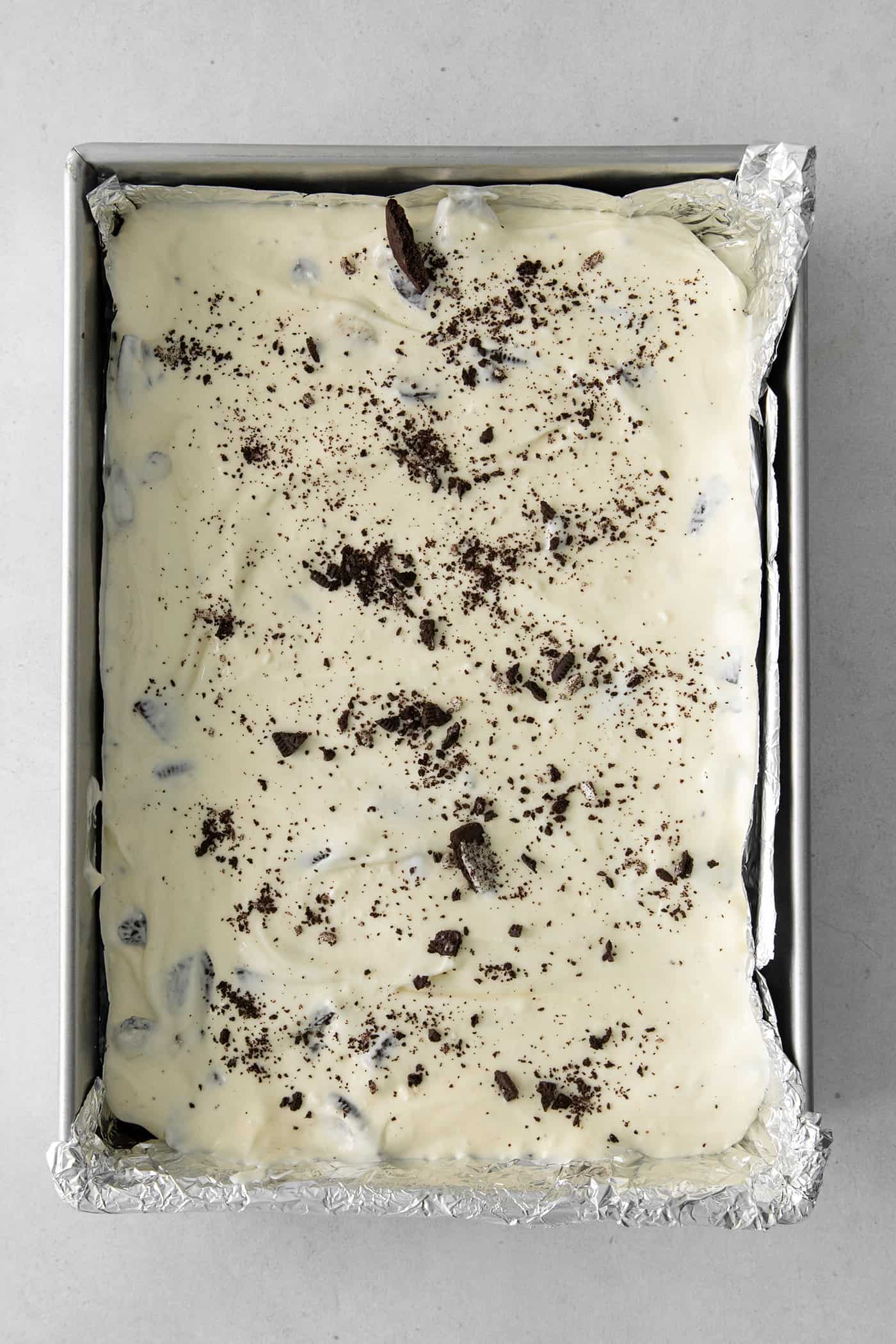 A cake pan of Oreo cheesecake batter