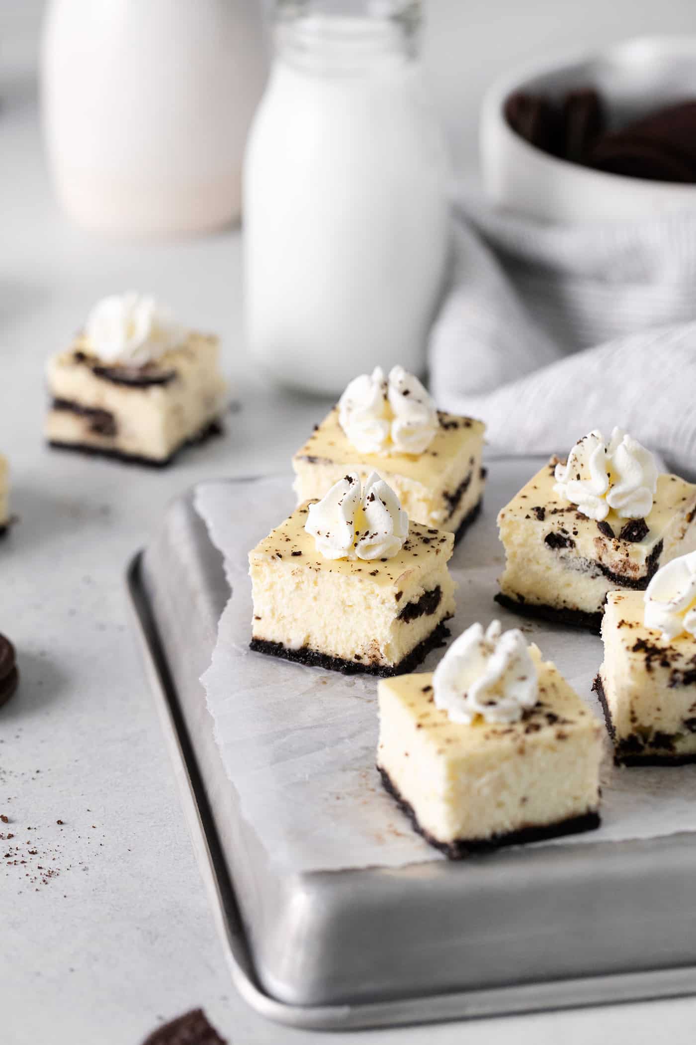 Mini cheesecake bites topped with whipped cream