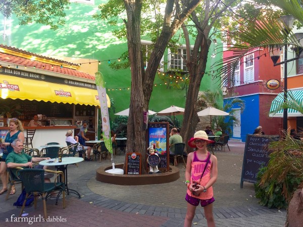 a girl standing in front of a restaurant