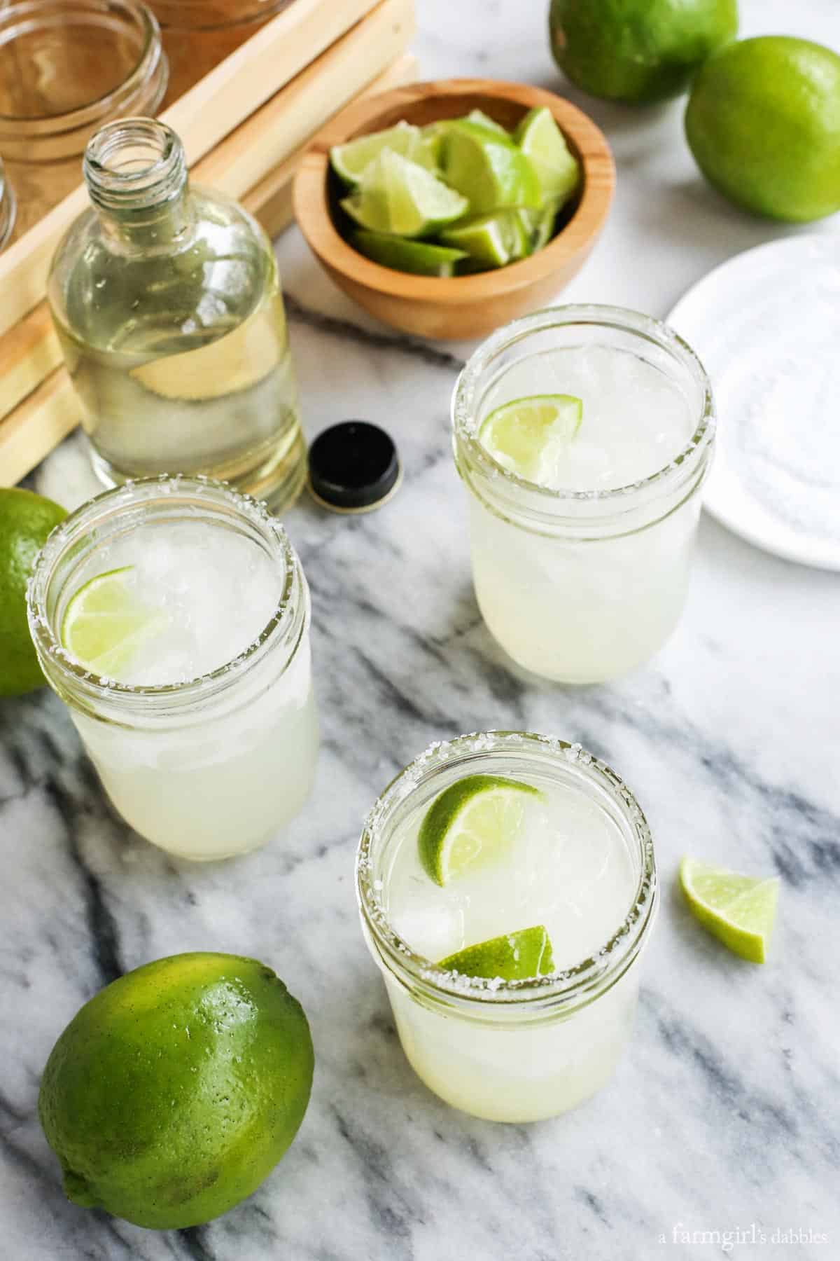 three mason jars of Margarita with simple syrup and limes