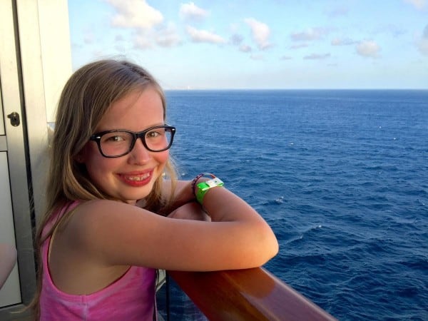 a girl on the balcony of a cruise ship