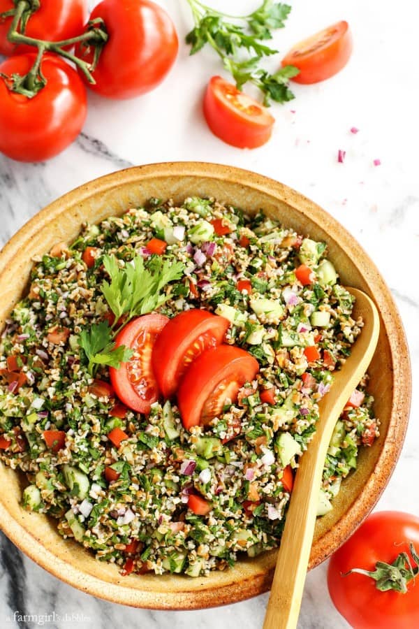 Tabbouleh in a pottery bowl with fresh tomatoes