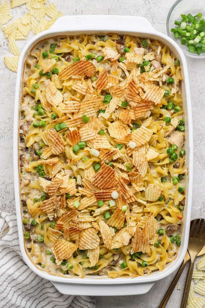 This sour cream and onion tuna noodle casserole is creamy, comforting and delicious. It’s an easy, nostalgic dinner with a bold flavor twist! Baking dish with sour cream and onion tuna noodle casserole.