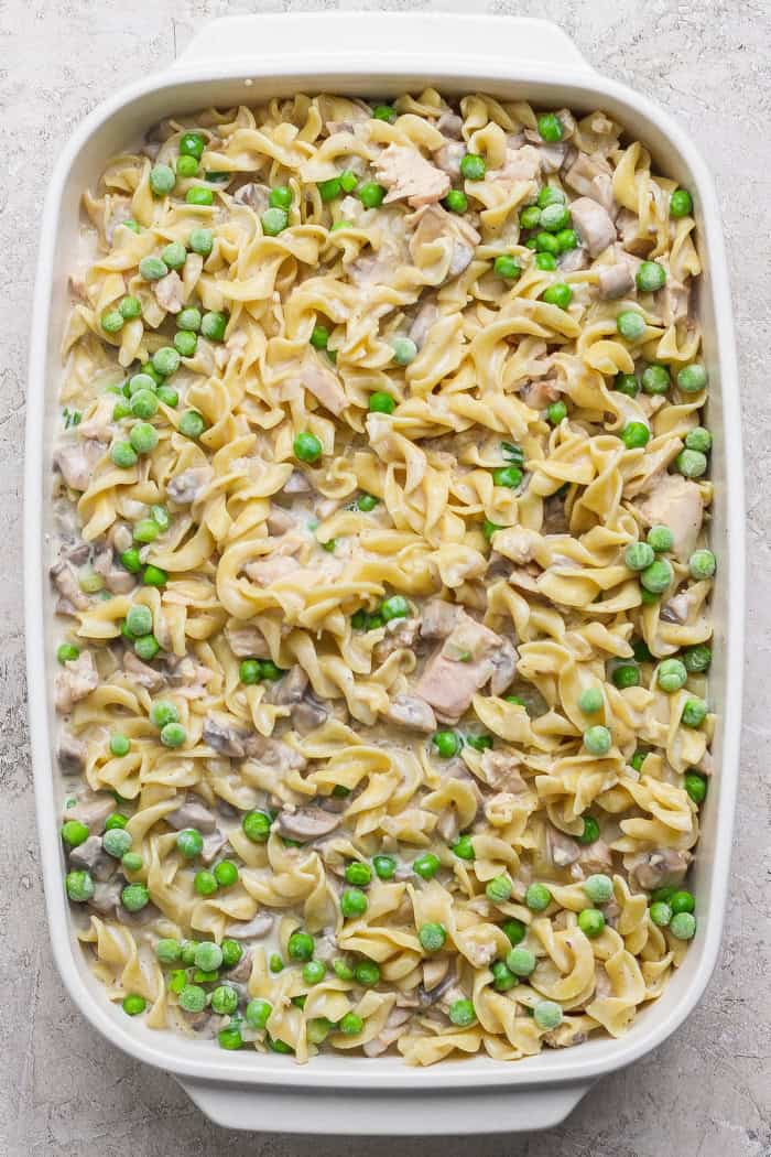 This sour cream and onion tuna noodle casserole is creamy, comforting and delicious. It’s an easy, nostalgic dinner with a bold flavor twist! Casserole dish with sour cream and onion tuna noodle casserole before adding potato chips.