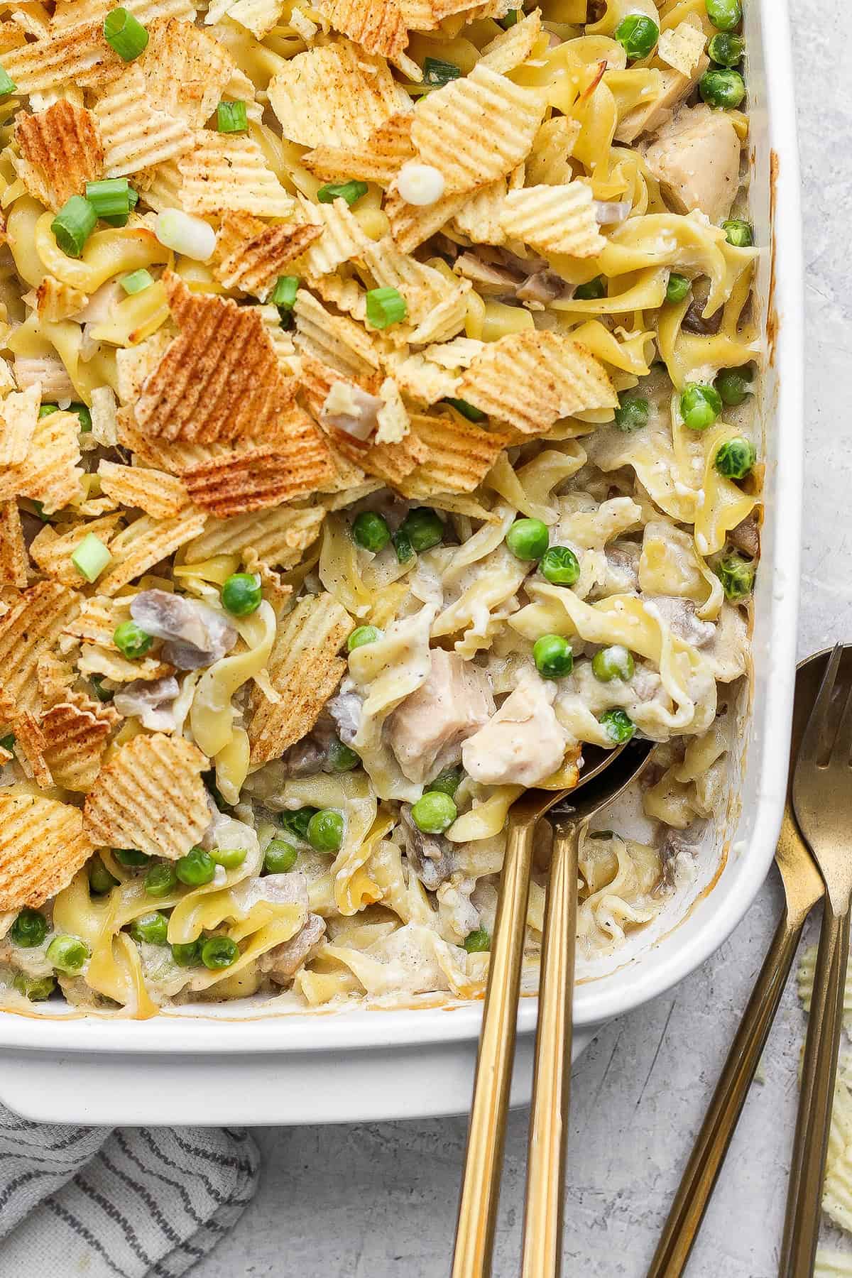 This sour cream and onion tuna noodle casserole is creamy, comforting and delicious. It’s an easy, nostalgic dinner with a bold flavor twist! Homemade sour cream and onion tuna noodle casserole in baking dish.