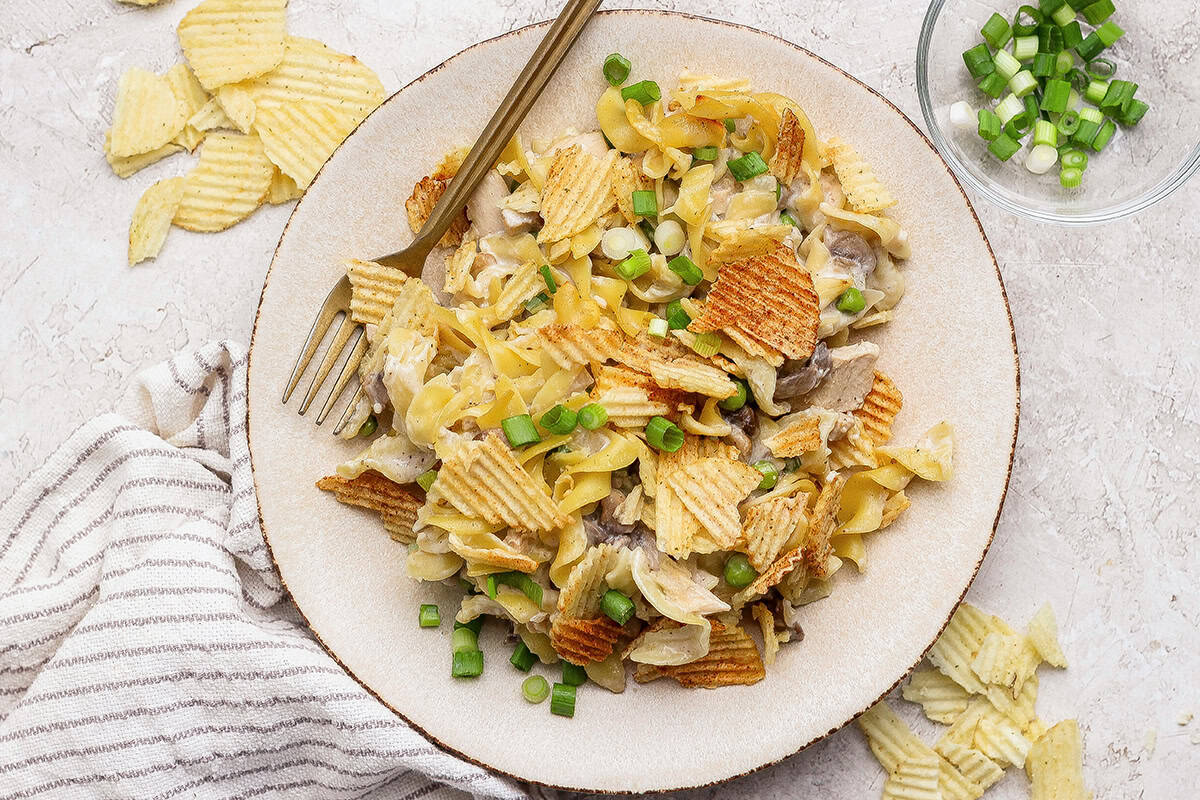 This sour cream and onion tuna noodle casserole is creamy, comforting and delicious. It’s an easy, nostalgic dinner with a bold flavor twist! Plate of sour cream and onion tuna noodle casserole with fork.