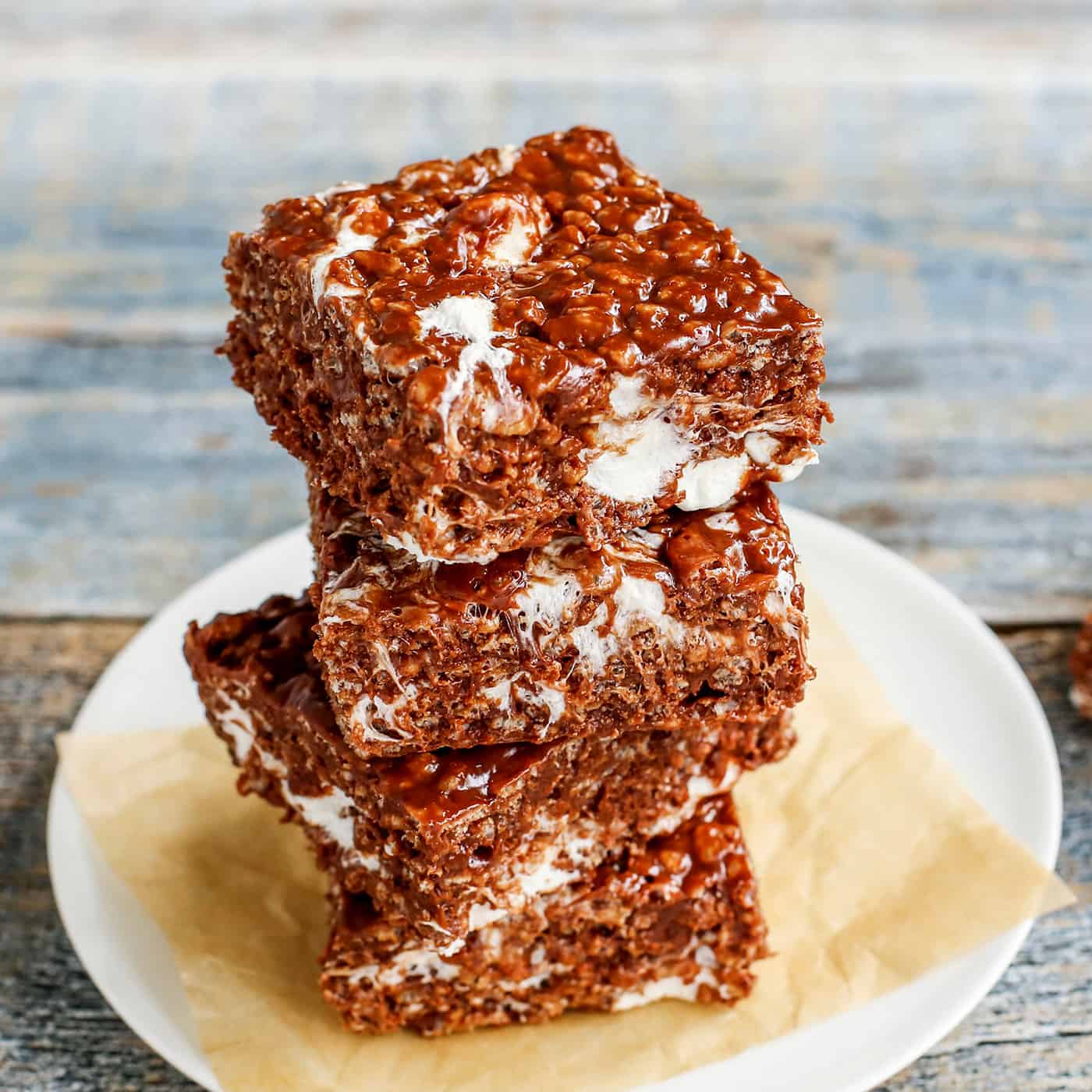 3 chocolate rice krispies bars stacked on a plate