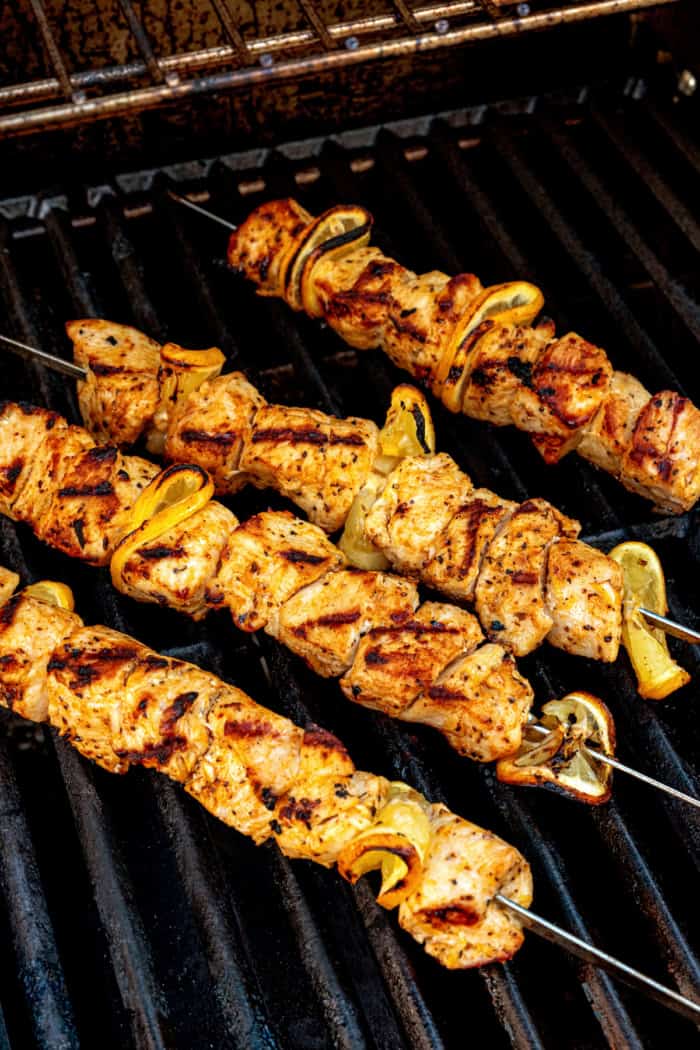 These Grilled Lemon Pepper Chicken Skewers are an easy summer recipe that's super fast for a weeknight. Don't skip the lemon butter sauce! Lemon pepper chicken skewers on grill