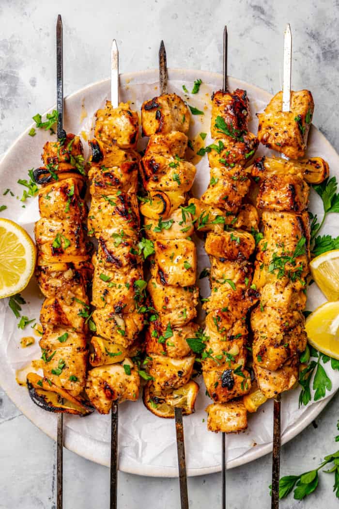 Platter of grilled lemon pepper chicken skewers