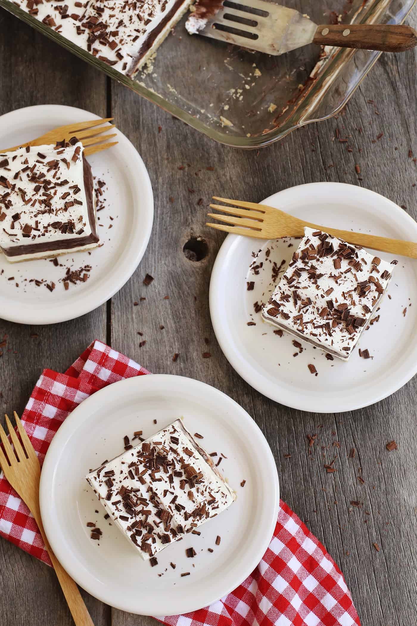 Three slices of layered pudding on plates