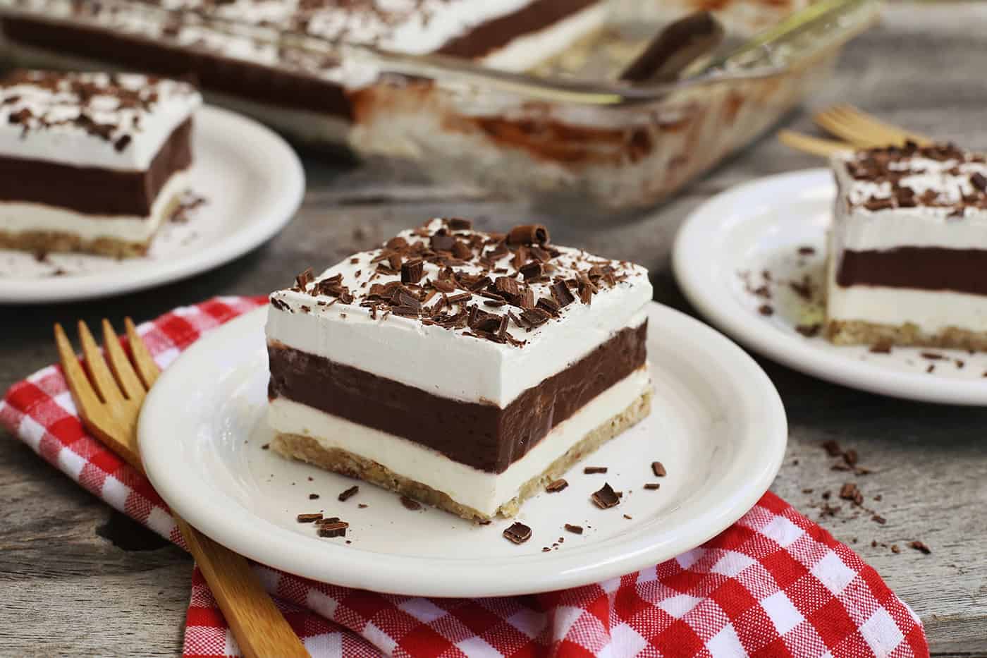 Three slices of layered pudding on plates
