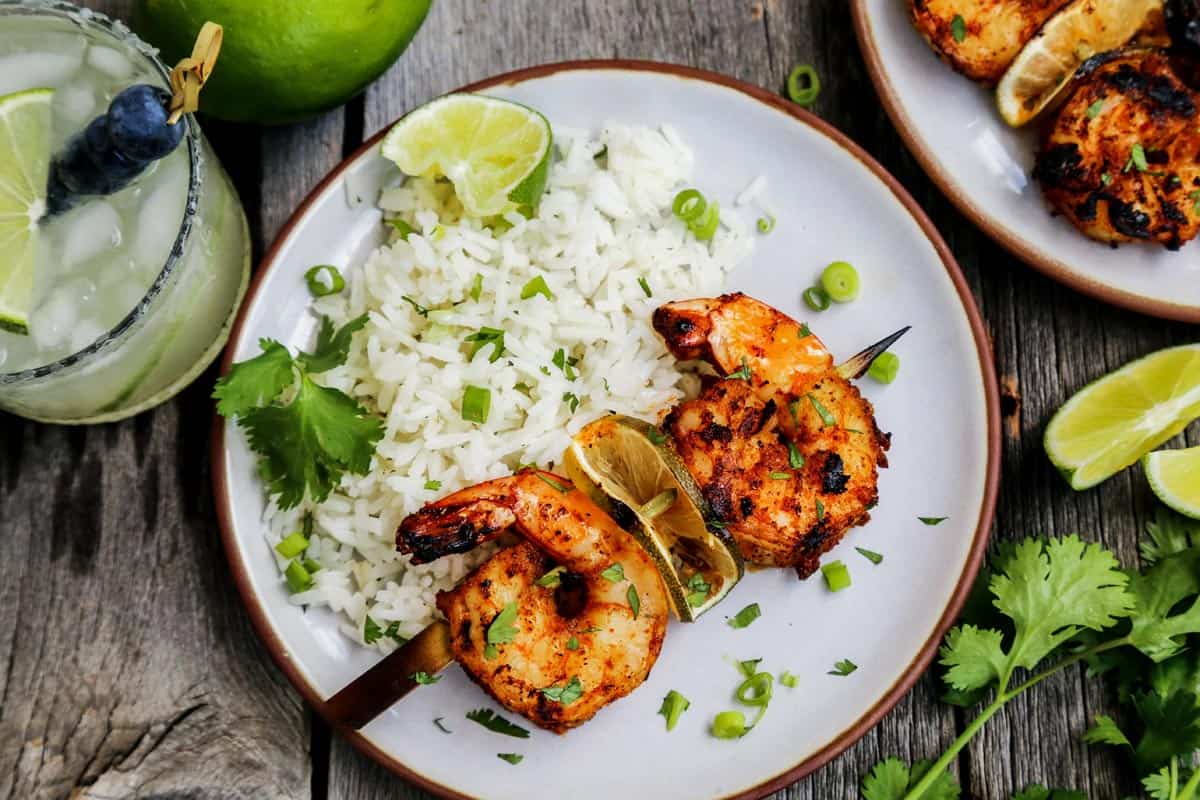 A plate of margarita grilled shrimp skewers ready to eat.