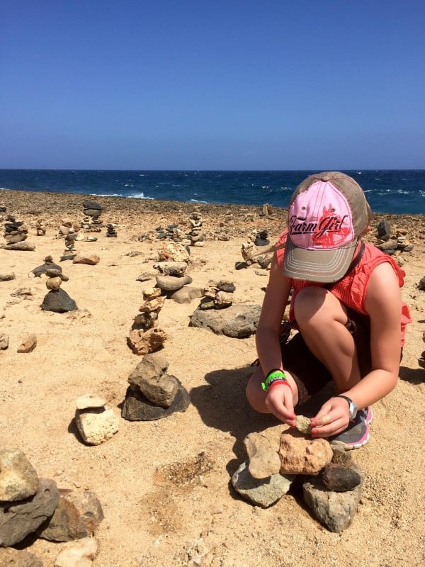 a girl stacking rocks