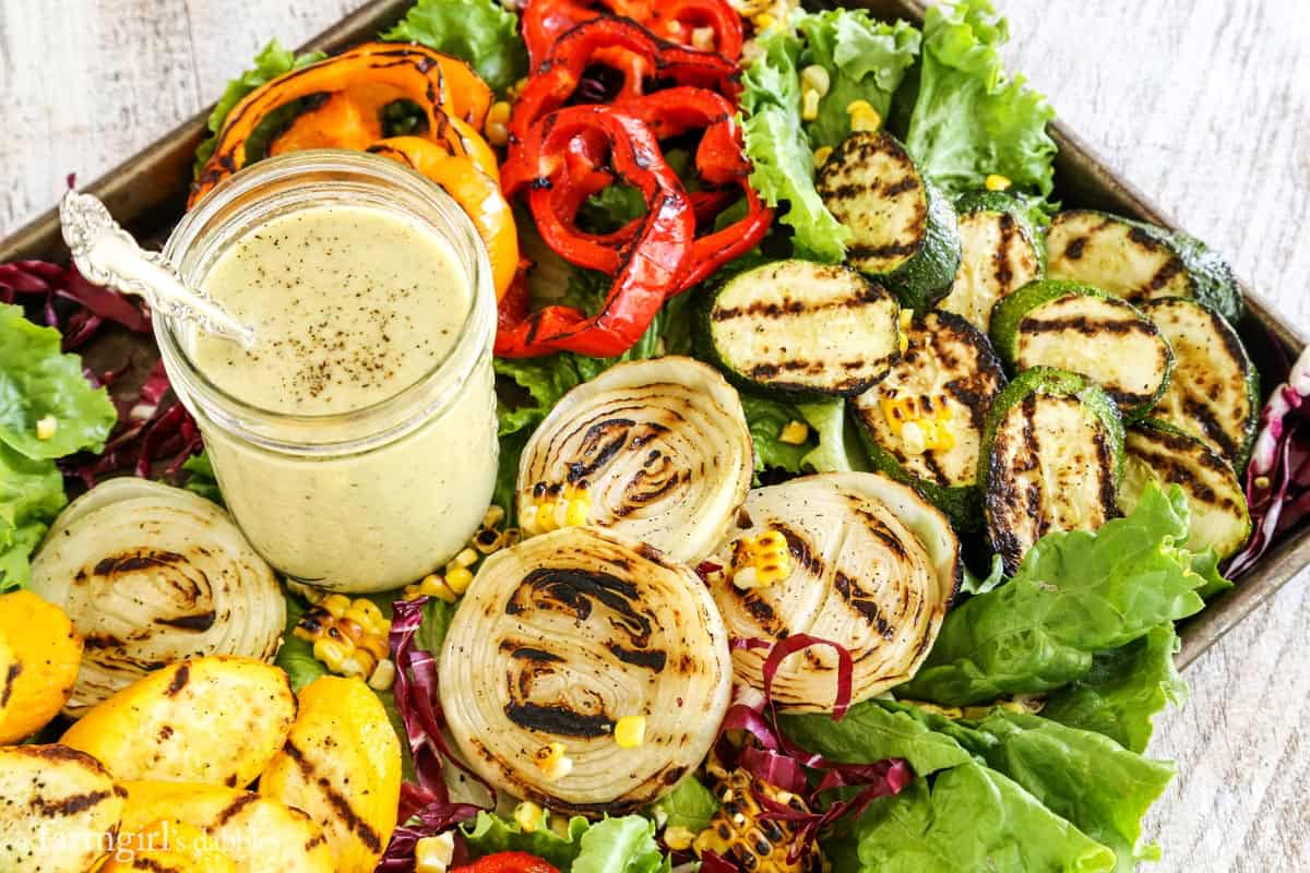 Grilled Vegetables with a mason jar of onion dressing.
