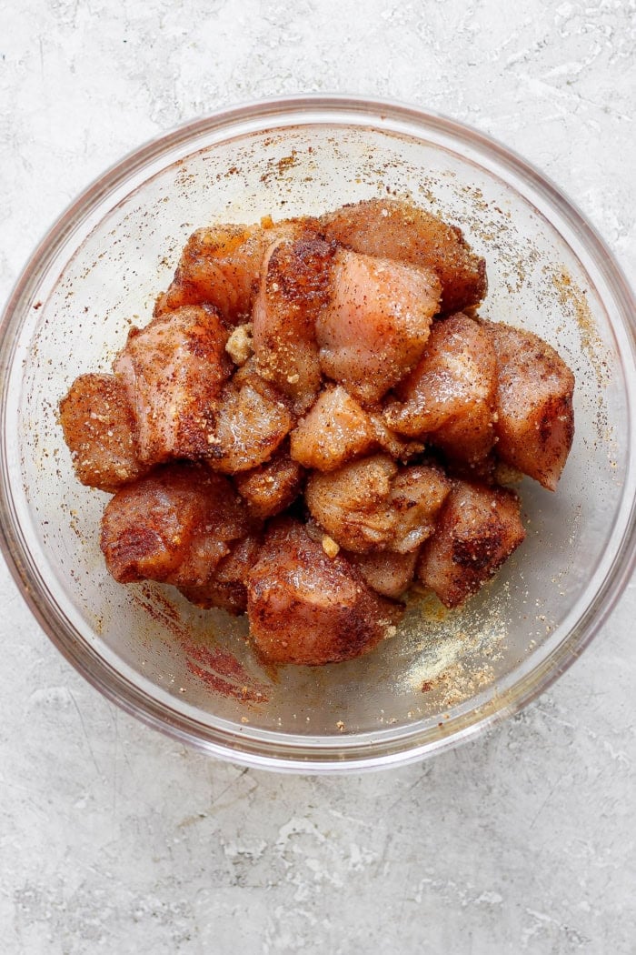 Overhead view of chicken marinating in bowl