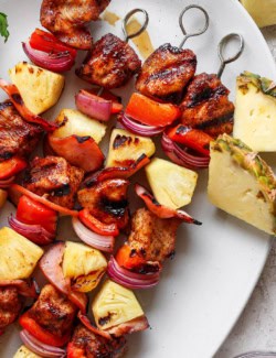 Overhead view of grilled Hawaiian chicken chili kabobs on platter