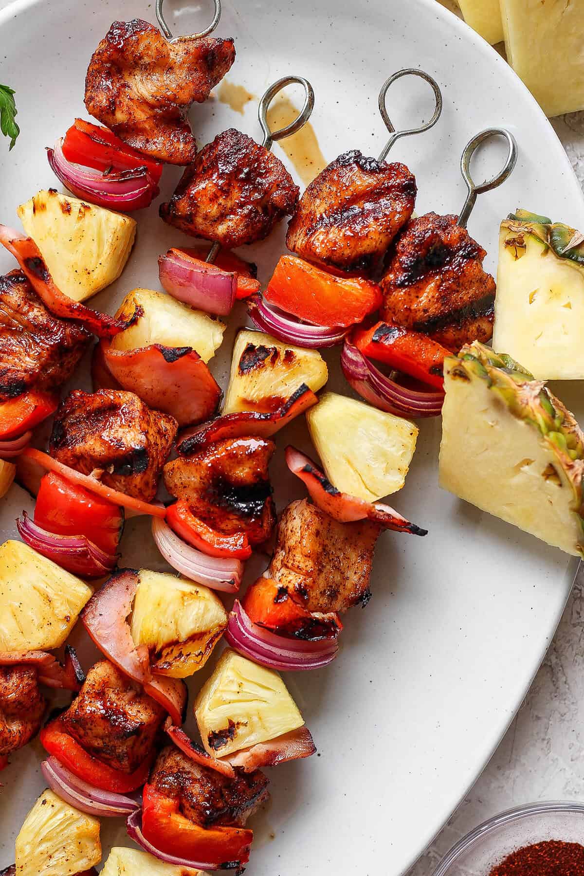 Overhead view of grilled Hawaiian chicken chili kabobs on platter