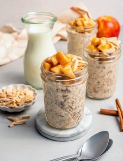 3 jars of overnight oats topped with cinnamon apples