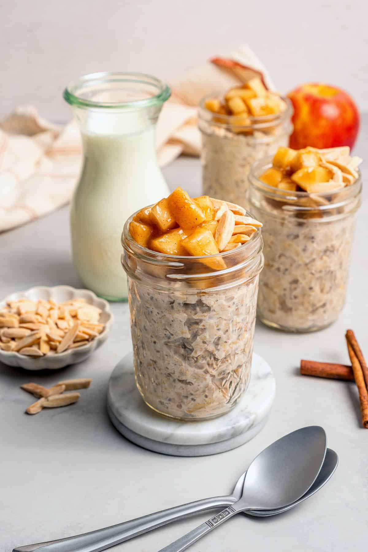 3 jars of overnight oats topped with cinnamon apples
