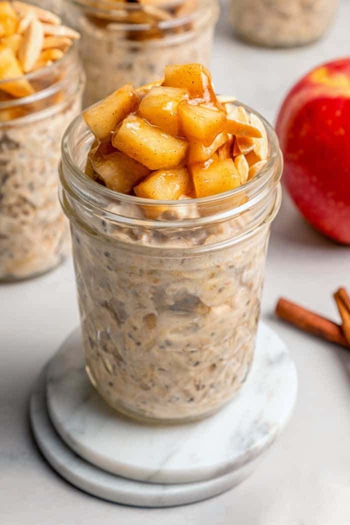 Jar of overnight oats topped with cinnamon apples