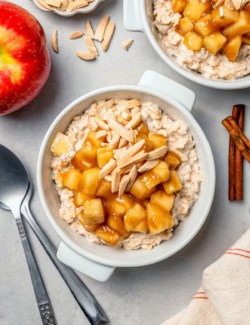 Overhead view of apple cinnamon overnight oats in bowl with slivered almonds on top