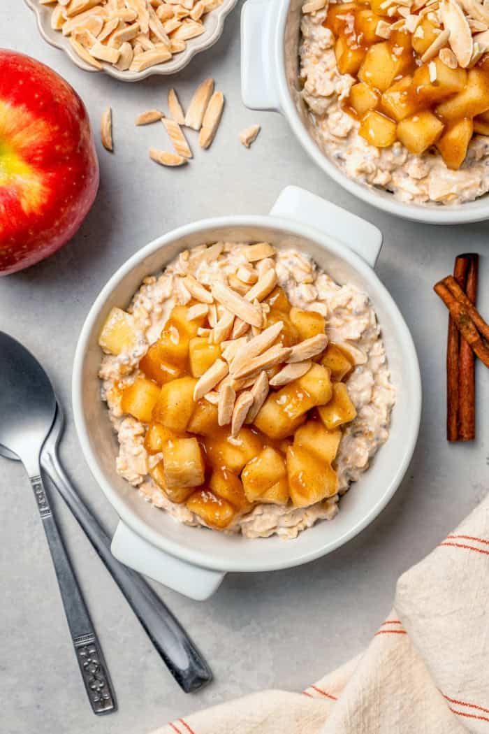 Overhead view of apple cinnamon overnight oats in bowl with slivered almonds on top