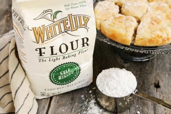 a bag of white lily baking flour and a measuring cup of flour