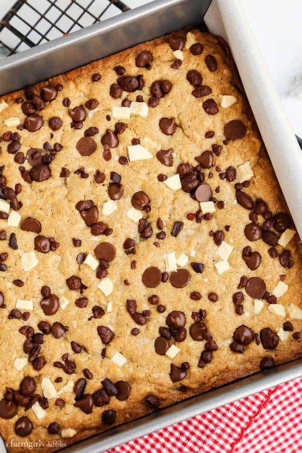 Triple Chocolate Coconut Blondies in a baking pan with a red checked tablecloth