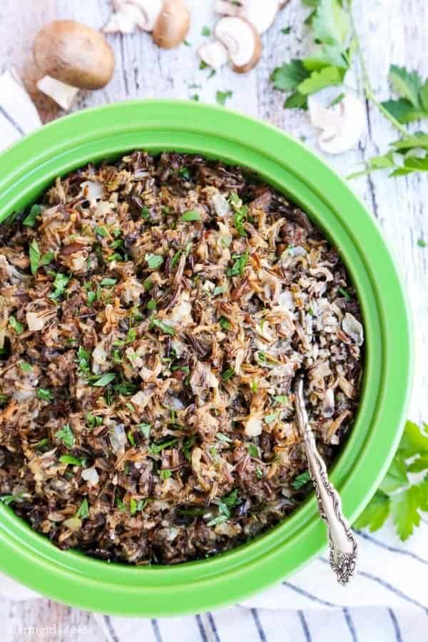 Creamy Wild Rice Casserole with Sausage and Mushrooms in a green dish