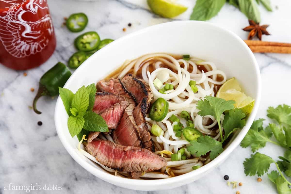 a bowl of Quick Grilled Beef Pho on a marble counter
