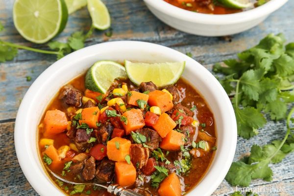 Slow Cooker Beef and Sweet Potato Soup bowls on a wood table