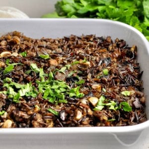 Wild rice casserole with mushrooms and sausage in baking dish.