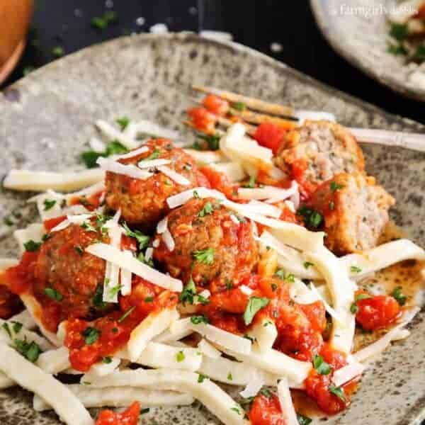 Spicy Italian Sausage Meatballs over Egg Noodles