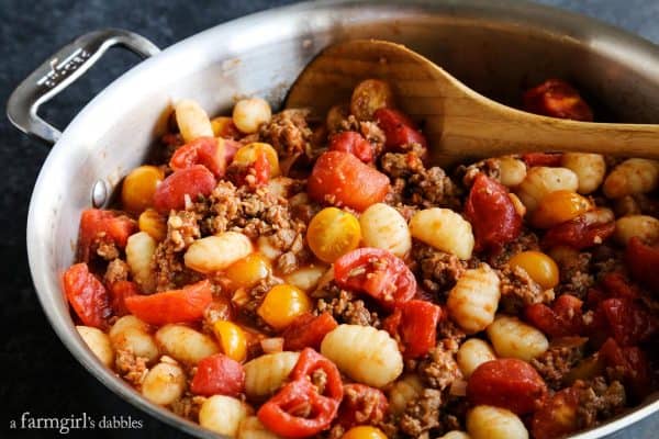 gnocchi, sausage, and tomatoes in a skillet