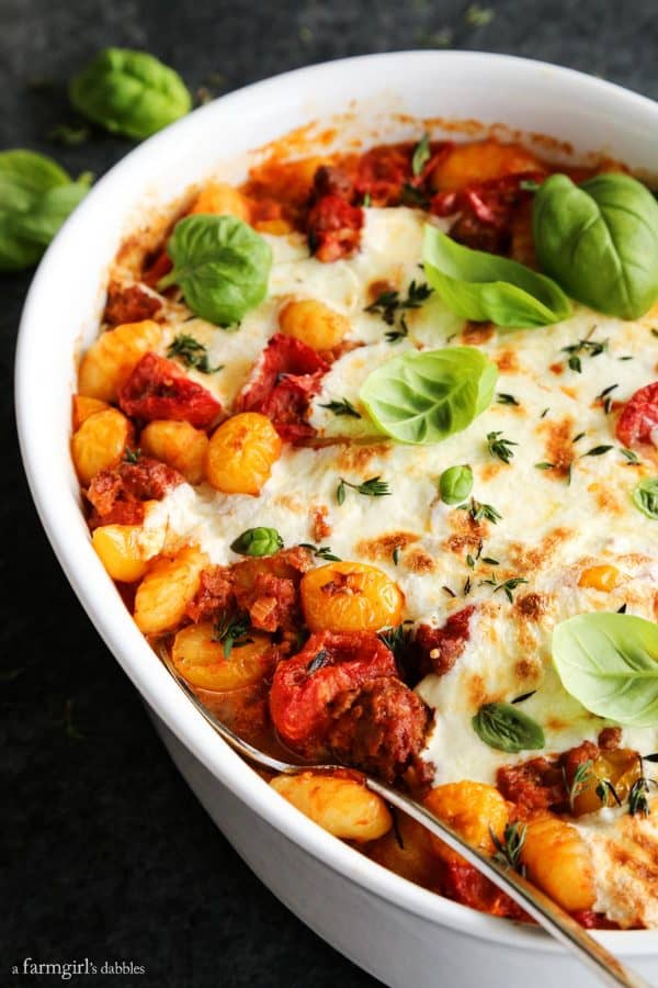 a dish of Cheesy Baked Gnocchi with Tomatoes and Sausage