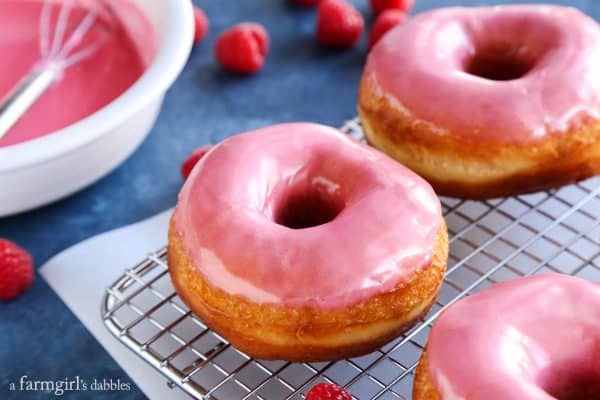 A close up photo of Yeast Donuts with Fresh Raspberry Glaze