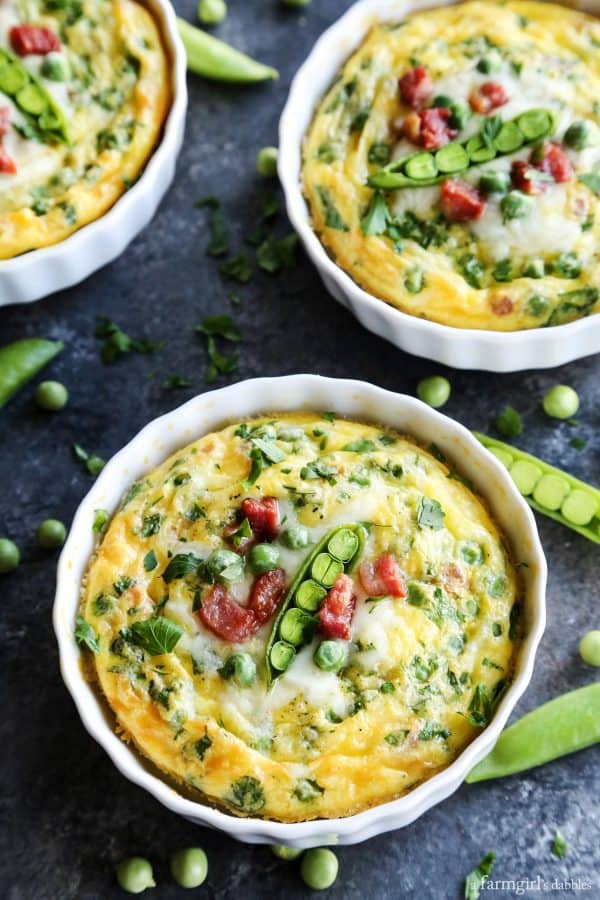 three dishes of Baked Eggs with Pancetta, Provolone, and Peas