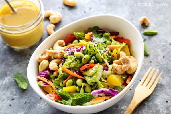 bowl of Chopped Salad with Coconut Green Curry Dressing and a wooden fork