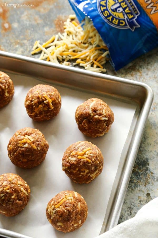 unbaked meatballs on a baking pan