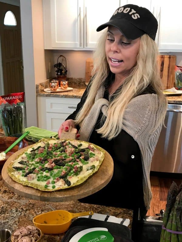 woman holding a pizza