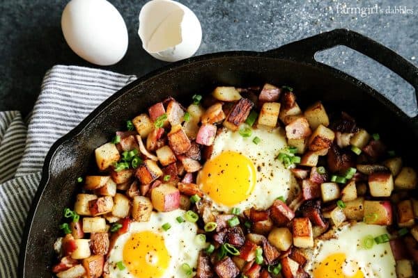 potato hash with eggs and bacon in a cast iron skillet