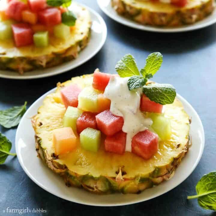 a slice of pineapple with cubes of melon on top