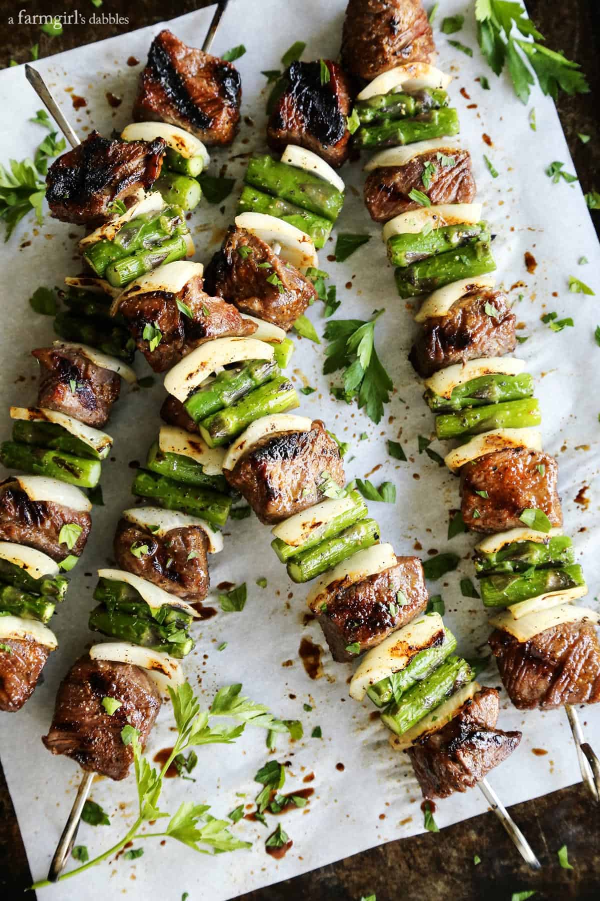 Sugar Grilled Beef and Asparagus Kebabs on parchment paper