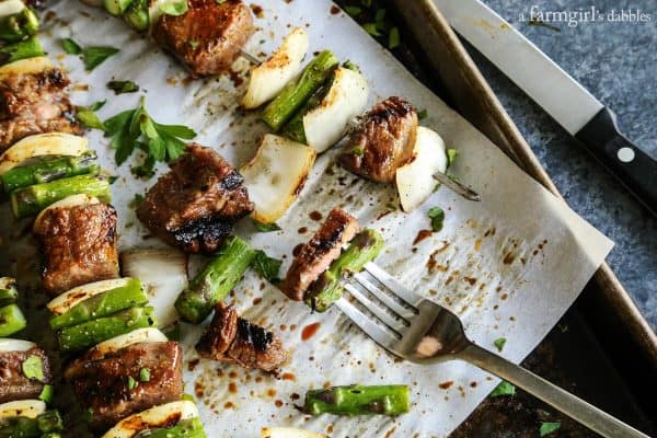 a fork with steak and asparagus