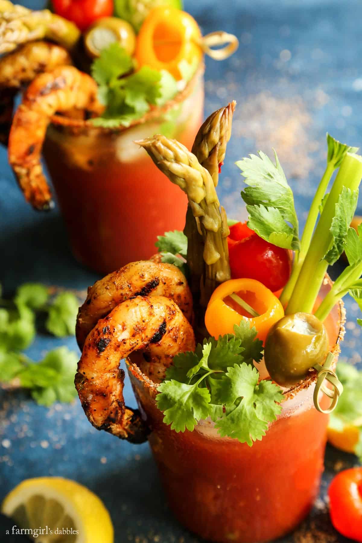 5 Pepper Bloody Mary with Grilled Jalapeño Shrimp in a glass.