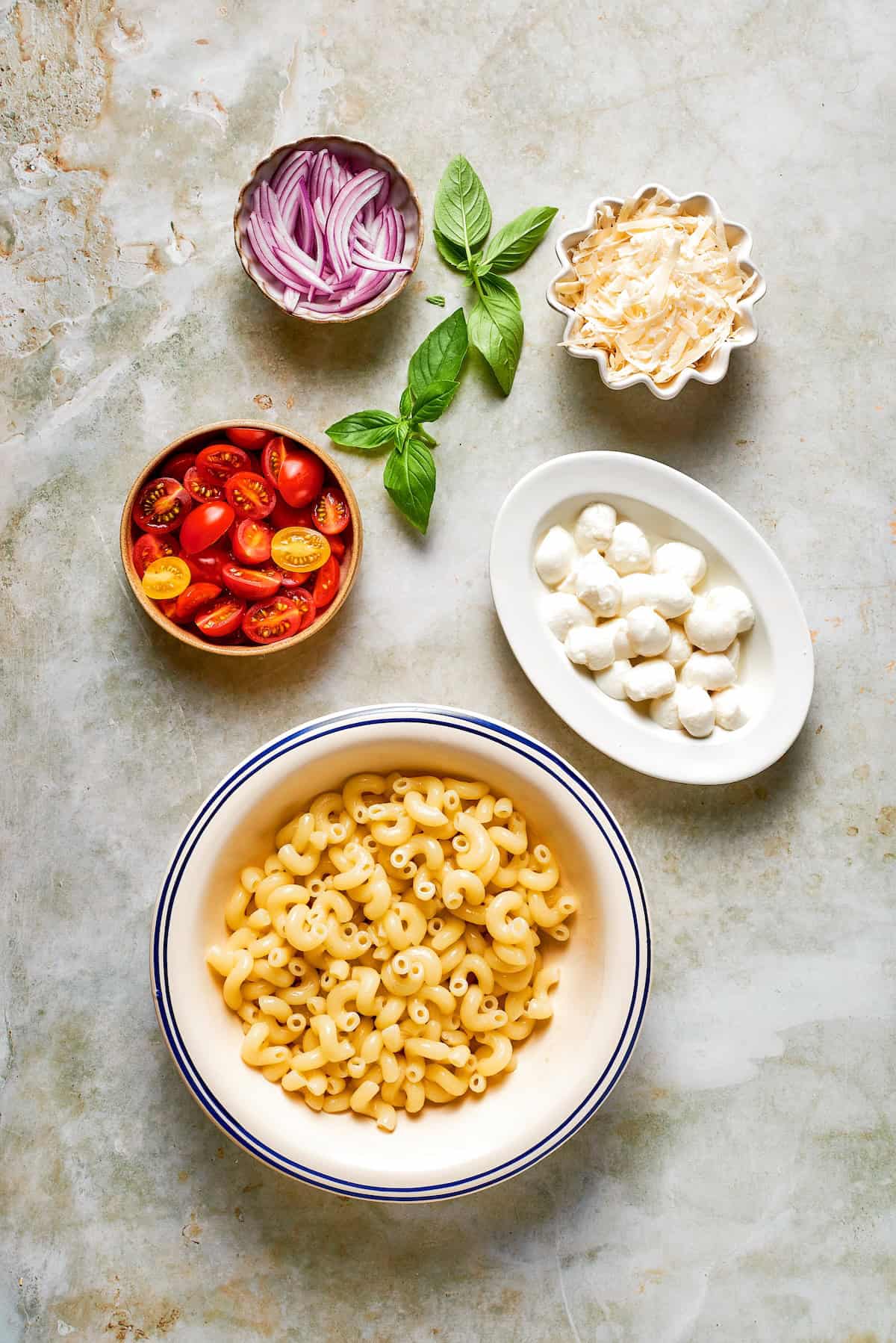 Cavatappi is tossed with juicy tomatoes, creamy mozzarella, basil, Parmesan and a bright balsamic dressing in this fresh caprese pasta salad. Ingredients for caprese pasta salad.