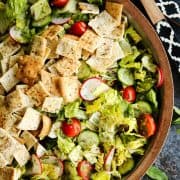 Fattoush Salad with wooden serving spoons