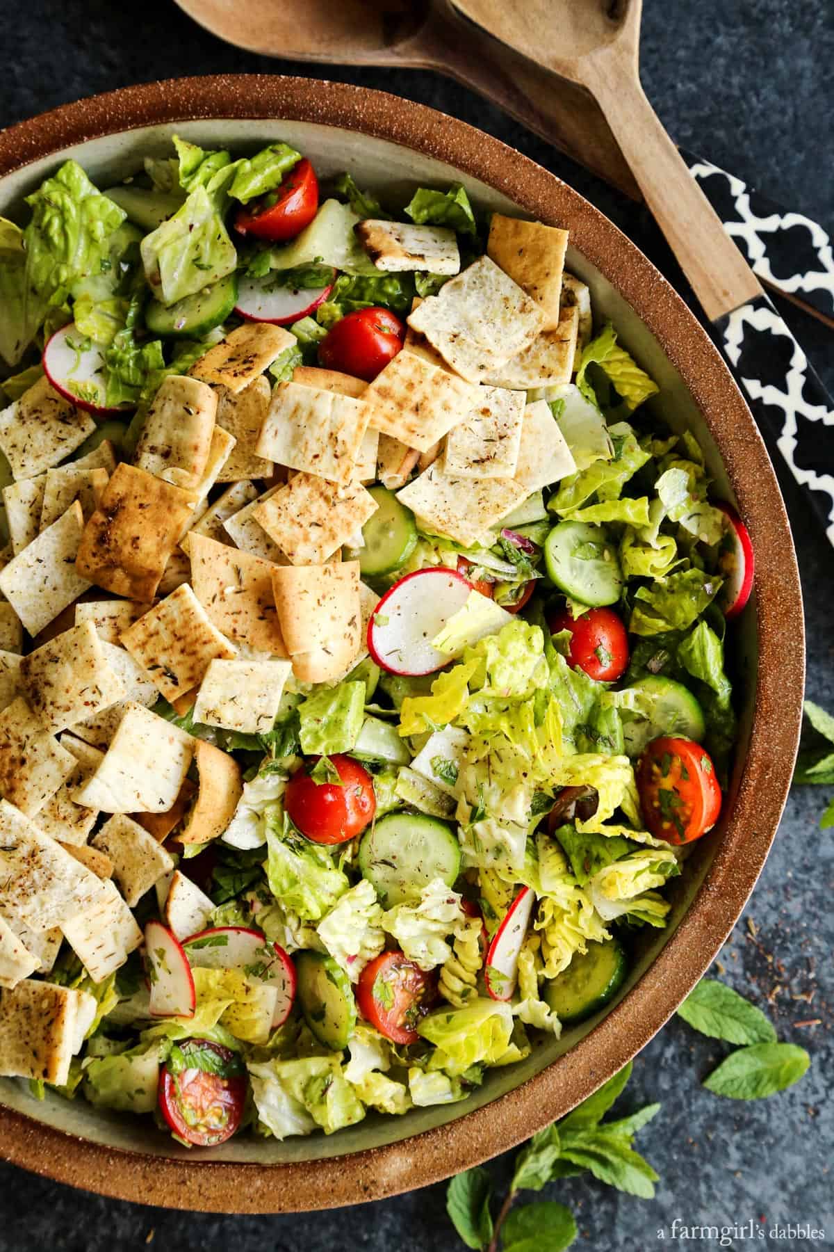 Fattoush Salad with wooden serving spoons