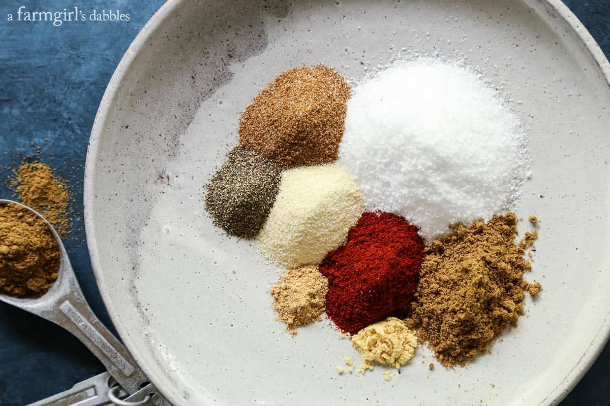 Measured ingredients for rim salt, on a white pottery plate.